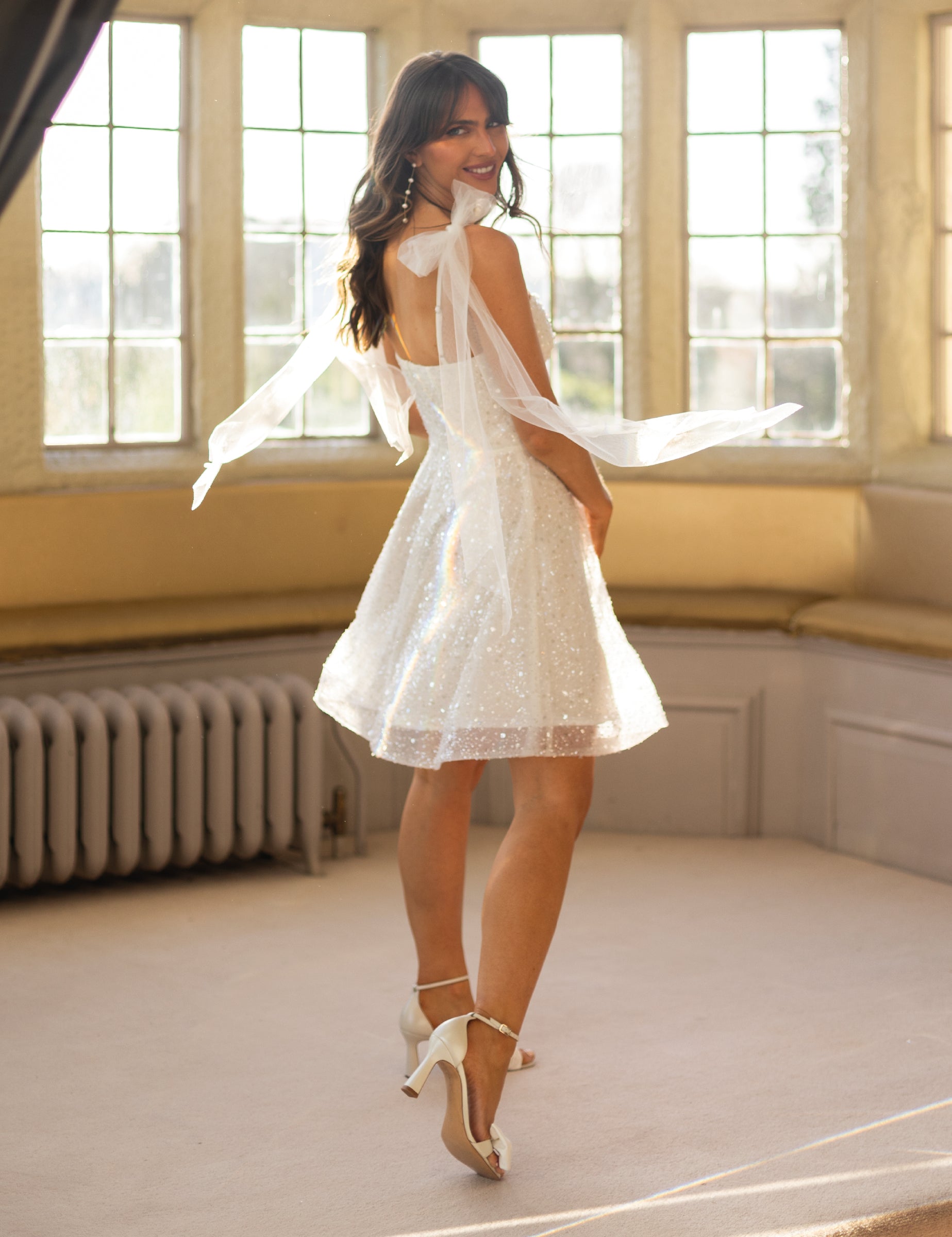 Short white lace occasion dress with corset
