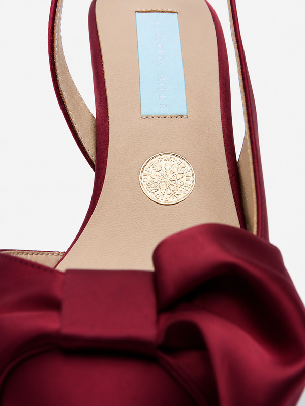 Charlotte Mills Mia Mid Wine Satin Slingback with asymmetric bow detail - close up of silver sixpence coin detail